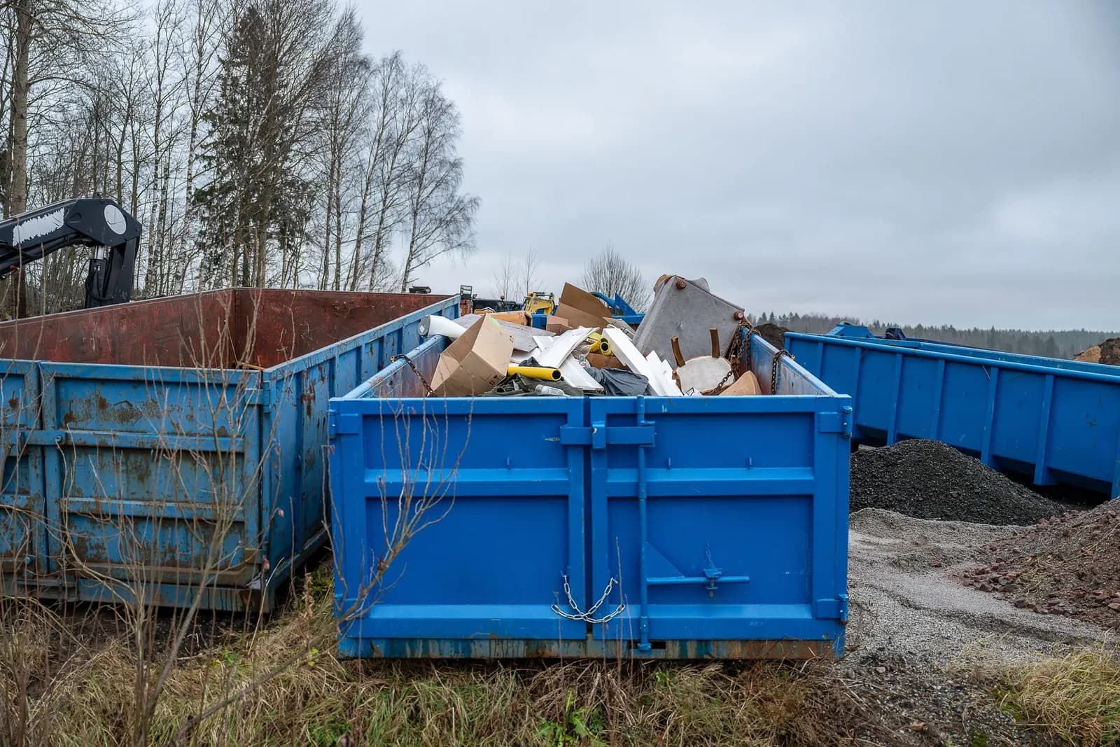 Loaded roll-off containers holding construction debris and household junk